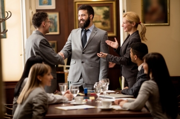 businessmen or lawyers shaking hands after completion of work